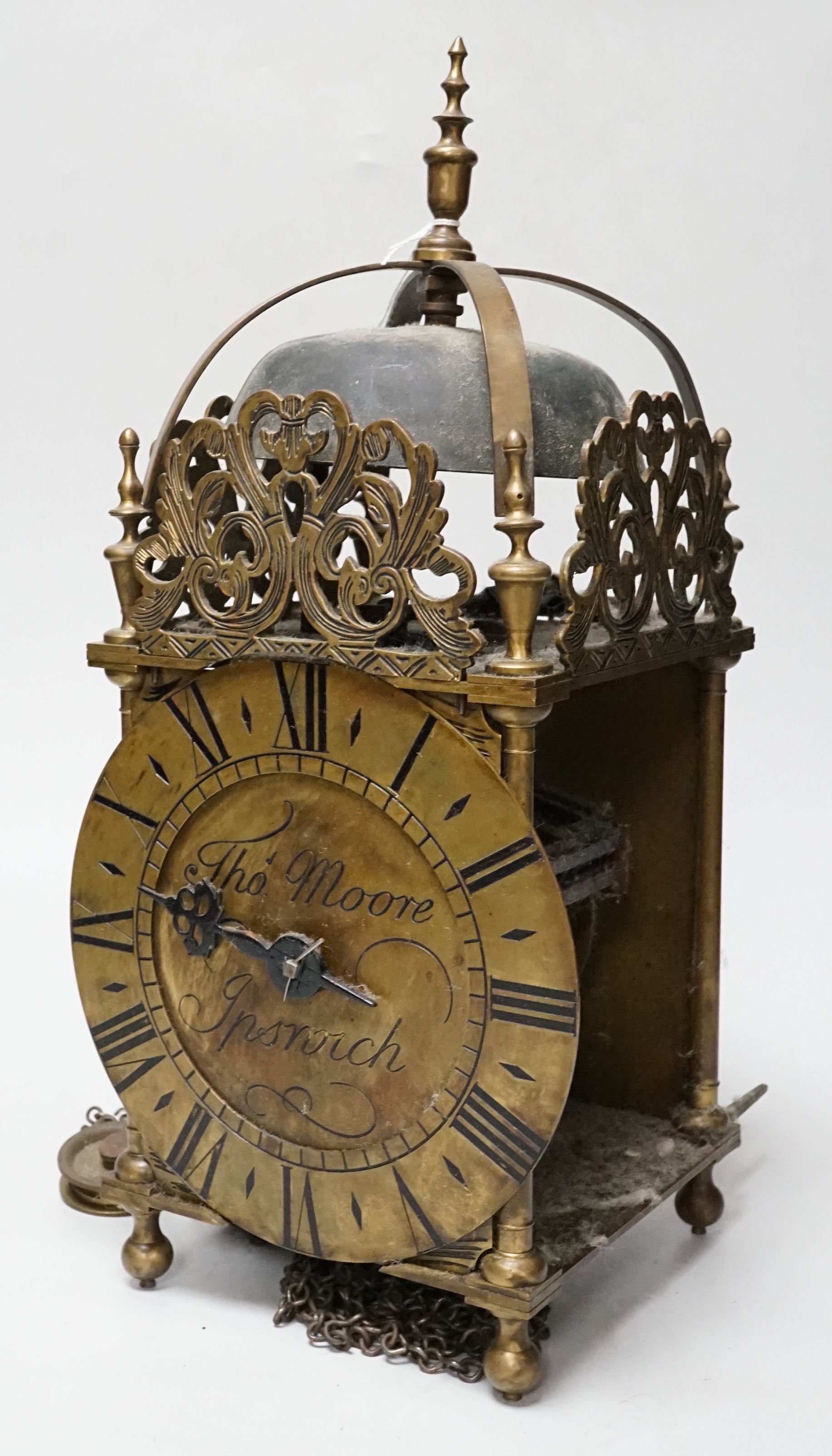 An English brass lantern clock with four branch finial decoration signed Tho Moore of Ipswich, 36cm tall